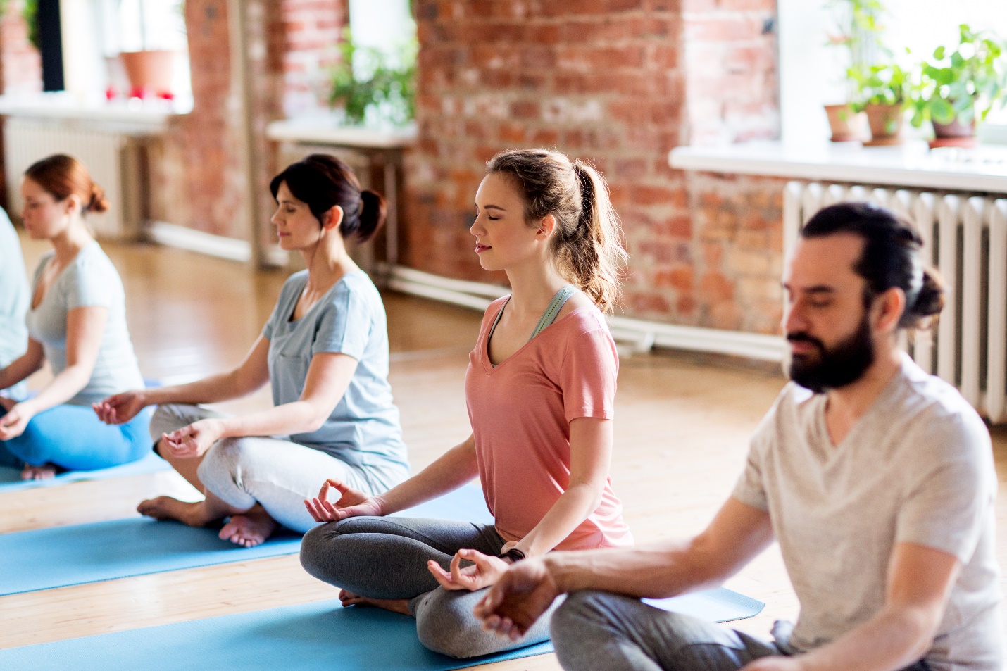A group of rehab patients practicing meditation and yoga.