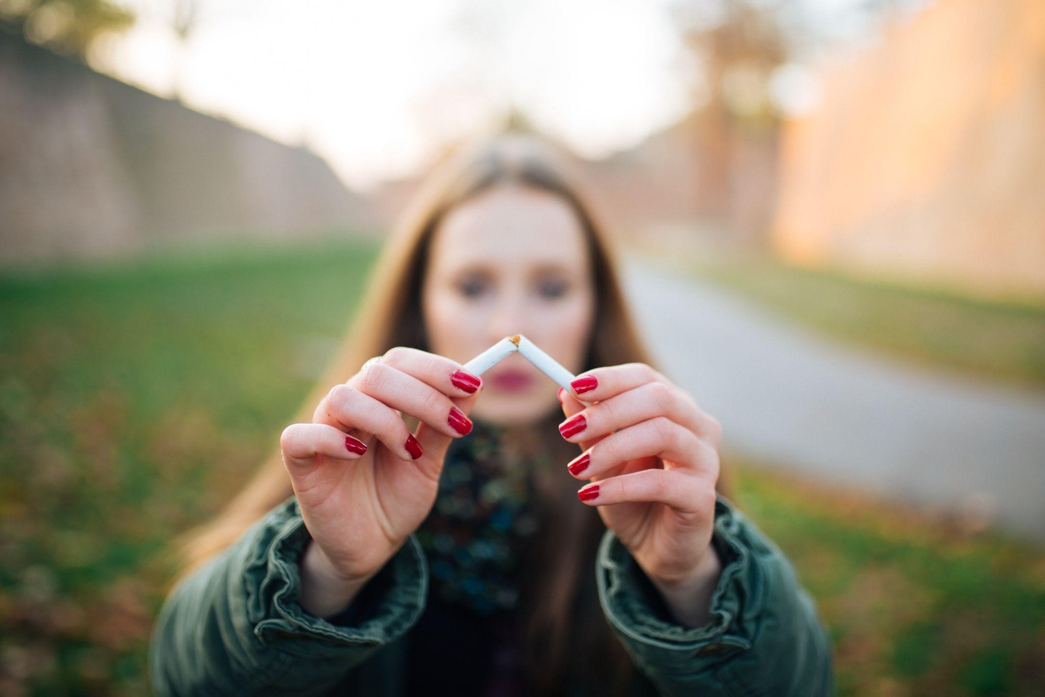 Beautiful Girl Holding Broken Cigarette In Hands.
