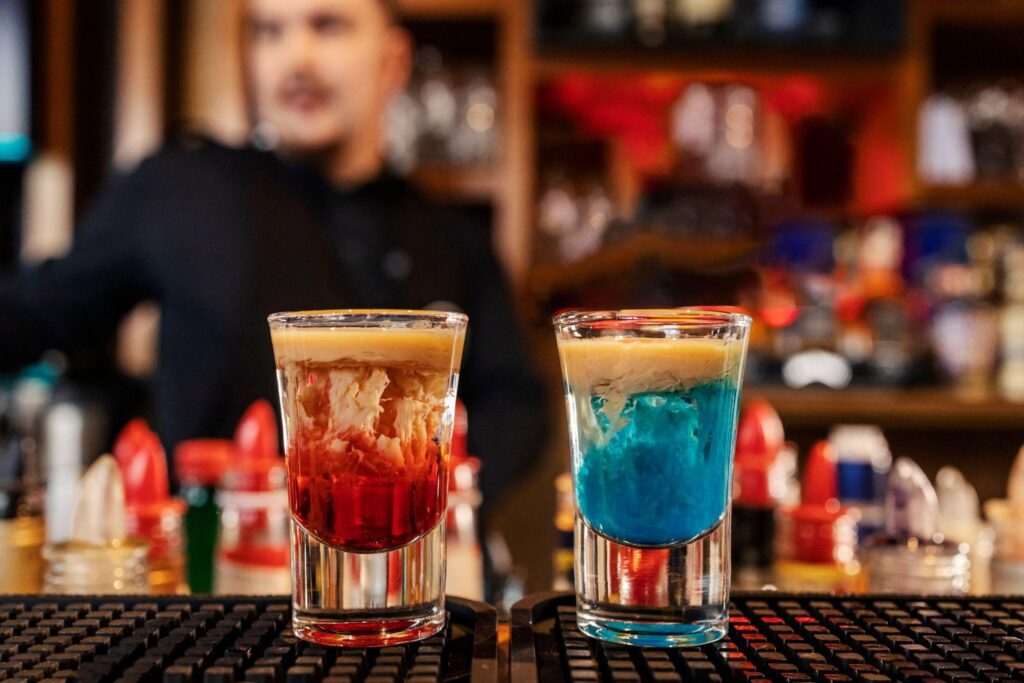 close up of two monkey brain shot cocktails on bar counter in a bar