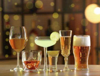 different alcohol drinks on wooden table indoors