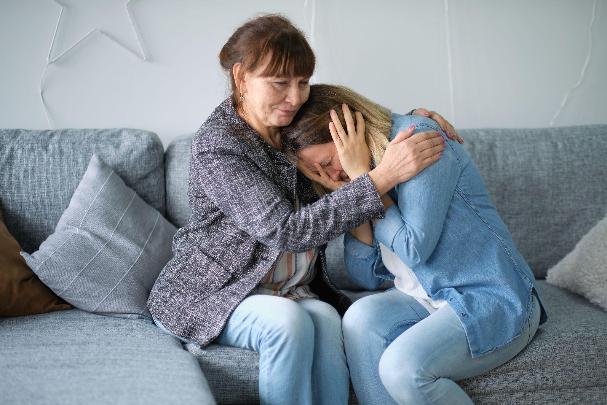 elderly mother hug crying adult daughter show support and care