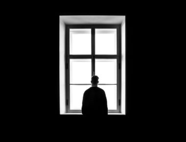 Man Standing In Front Of The Window