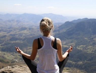 Woman Meditating On Mountain1